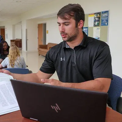 a student works at a laptop